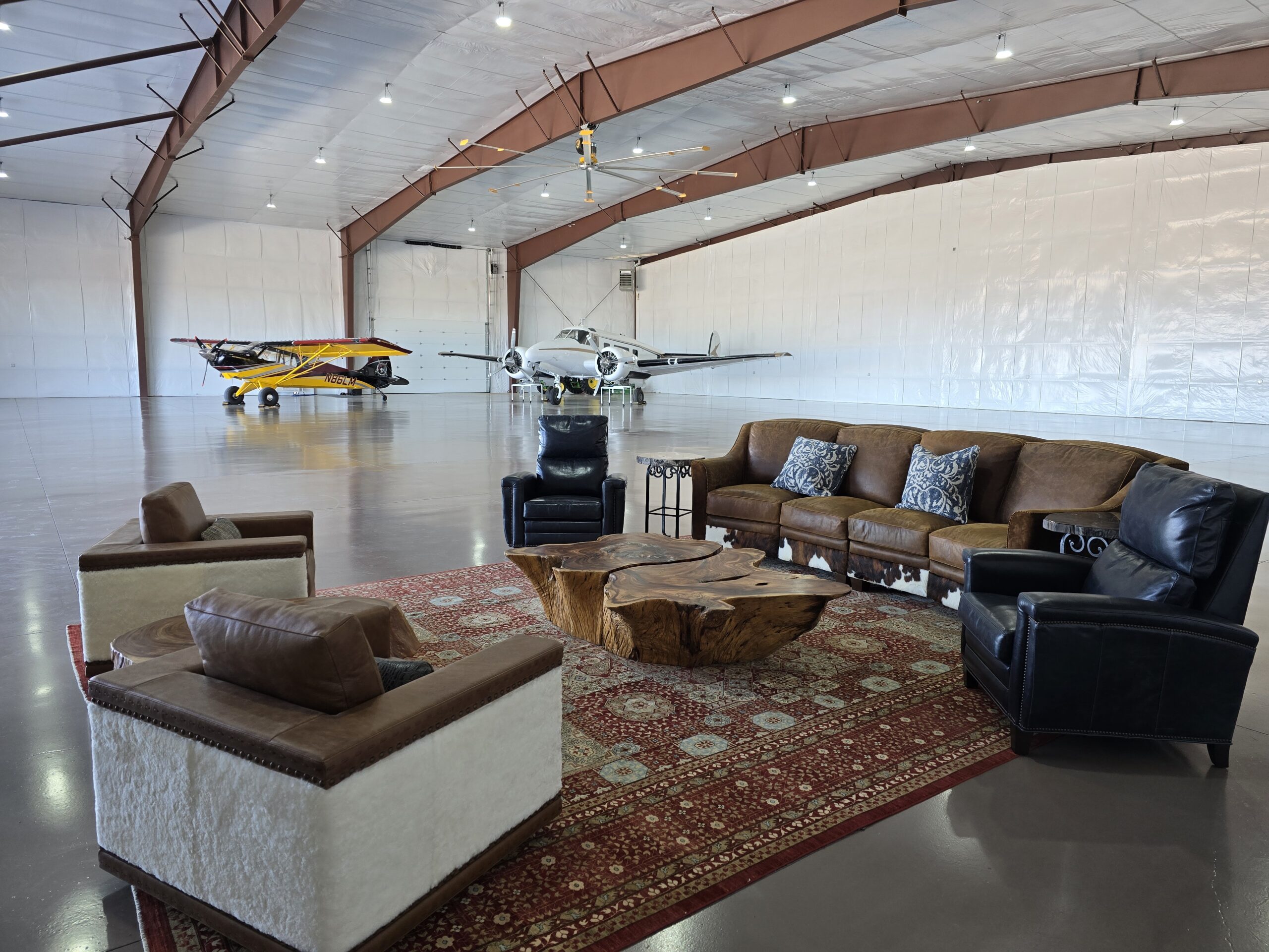 Furniture in a plane hanger with two planes